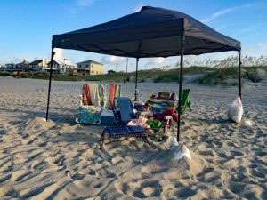 Wind tossed beach furniture and umbrellas.