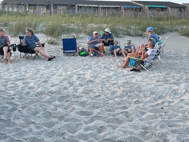Volunteers sitting on the beach.