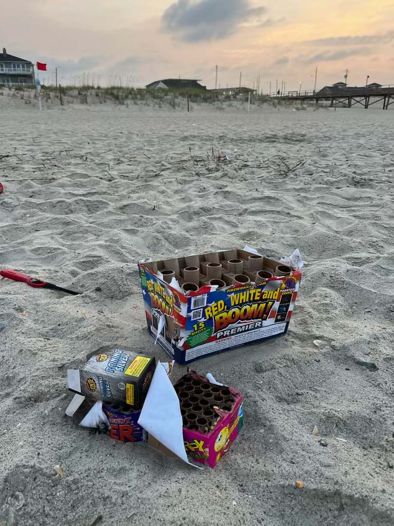 Trash from fireworks left on the beach.